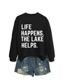 Detail view of cotton sweatshirt with white Life Happens lettering and distressed denim shorts - Black (White Letters)