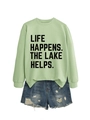 Detail of light green sweatshirt with Life Happens letter print and distressed denim shorts - Olive Green (Black Font)