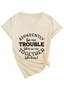 Close-up of beige V-neck t-shirt with front print and decorative knot at the hem - S / Sand (Black Font)
