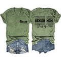 Detailed front and back view of V-neck Senior Mom 2026 tee and distressed denim shorts - Olive Green (Black Font Print)