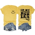 Close-up of In My Lacrosse Mom Era text and hockey sticks graphic on yellow t-shirt - Yellow (Black Print)