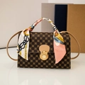 Detail of floral crossbody bag with gold lock and silk scarf wrapped handle - Brown Flower