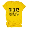 Detail of Free Hugs slogan print on yellow cotton t-shirt with classic crew neck - Yellow (Black Font)