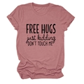 Close-up of soft dusty rose cotton t-shirt with 'FREE HUGS' slogan and crew neckline - Rose Gold (Black Font)