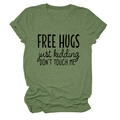Macro shot of FREE HUGS JUST KIDDING funny text print on heather green cotton t-shirt - Olive Green (Black Font)