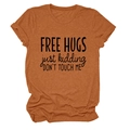 Detail of Free Hugs Just Kidding slogan print on rust orange short sleeve t-shirt - Burnt Orange (Black Font)