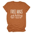 Detail of terracotta short sleeve t-shirt fabric with Free Hugs printed text design - Burnt Orange (White Font)
