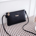 Crossbody phone purse in black faux leather with V-shaped stitching and golden leaf zipper - Black