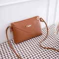 Brown faux leather envelope crossbody phone bag with metal Chleo logo and leaf zipper pull - Brown