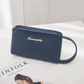 Navy blue lychee grain leather wristlet clutch bag with gold logo on white stand - Dark Blue
