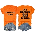 Flat lay of orange crewneck t-shirts with black baseball slogans and denim shorts - Orange