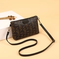 Brown monogram crossbody phone bag with VIFN pattern and gold hardware on white pedestal - Coffee and Black