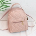 Pink quilted mini backpack for women featuring adjustable straps and gold metal charms - Pink