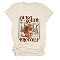 Detail of Quest Squad cat print on a cream t-shirt with pine forest and mountain graphic - S / Sand
