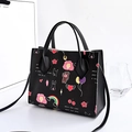 Black leather crossbody tote with colorful cartoon doodles and golden clasp hardware - Black Cartoon Graffiti