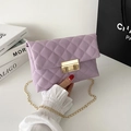 Lavender quilted shoulder bag with gold chain strap and metal clasp in a stylish finish - Purple