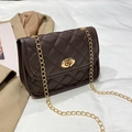 Deep brown quilted chain shoulder bag with golden twist lock on white fabric - Coffee