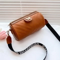 Brown leather cylinder crossbody bag with V-quilted pattern and a wide lettered strap - Brown