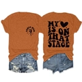 Detail of orange T-shirt showing My Heart Is On That Stage back print and denim shorts - Burnt Orange (Black Font)