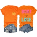 Detail of orange sun t-shirt and distressed denim shorts with boat lake waves print - Orange (Black Print)