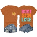 Detail of burnt orange t-shirt with SUN rays LAKE days art text and frayed denim shorts - Burnt Orange Front (Black Graphic)