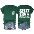 Flat lay of green t-shirt with SHIT SHOW SUPERVISOR print and ripped denim shorts - Retro Green (White Font)