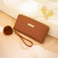 Brown long quilted wallet for women with gold metal plaque and fuzzy pom pom charm - Brown
