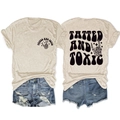 Flat lay of vintage beige T-shirt with Tatted and Toxic graphic and distressed denim shorts - S / Sand (Black Graphic)