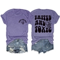 Flat lay of purple tatted and toxic graphic tee with distressed blue denim shorts set - Purple (Black Print)