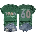 Detailed flat lay of vintage 1966 print V-neck t-shirt with distressed denim shorts - Vintage Green