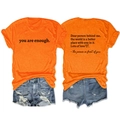 Front and back detail of bright orange cotton t-shirt with social quote printing - S / Tops / Orange