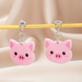 Detail view of cute pink piglet acrylic clip-on earrings with comfortable metal screw back - Pig