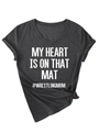Detail of charcoal grey V-neck t-shirt featuring side knot hem and wrestling mom slogan - Heater Grey (White Font)