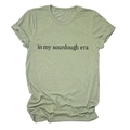 Detailed close-up of in my sourdough era text on a sage green cotton t-shirt - S / Olive Green (Black Font)