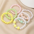 Colorful plastic pearl bracelet set for girls with cute floral and candy beads - Pearl Bracelet Collection