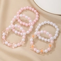 Set of 6 cute pink and white beaded bracelets for girls with butterfly and flower charms - Flower And Butterfly Bracelet Assortment
