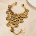 Bohemian gold hand harness with engraved coins and star ring on silk background - Gold