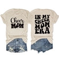 Flat lay of Cheer Mom Era T-shirt and distressed denim shorts with vintage printed details - S / Sand (Black Font)