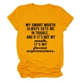 Close-up of printed slogan text and fabric texture on a bright orange crew neck T-shirt - S / Mustard Yellow (Black Font)
