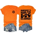 Detail view of orange dog groomer t-shirt and ripped denim shorts laid flat on white background - Orange (Black Font)