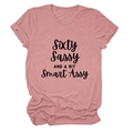 Flat lay of pink cotton T-shirt featuring black Sixty Sassy cursive typography print - Rose Gold (Black Font)