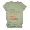 Detail of army green crewneck t-shirt with orange slogan and soft cotton texture - Olive Green