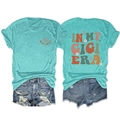 Detail of In My Gigi Era slogan with daisy prints on mint green t-shirt and denim shorts - Deep Water Blue