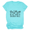 Detailed close-up of plant print and 'We all grow at different rates' text on teal T-shirt - S / Deep Water Blue (Black Letters)