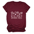 Close-up of wine red t-shirt with rolled sleeves and botanical inspirational print - S / Wine Red (White Letters)