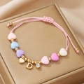 Macro detail of handmade pink beaded bracelet with heart charms and crystal letter D pendant - Letter D