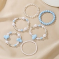 Detail von 6er-Set blau-weißen Perlenarmbändern mit Stern- und Herzanhängern - Blau