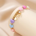 Detail of macaron heart beads with gold K letter and rhinestone charms on pink cord - Letter K