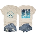Flat lay of oatmeal T-shirt with lake slogan and ripped denim shorts summer outfit - S / Sand