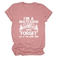 Detail of loose fit crew neck t-shirt in dusty rose with white slogan print text - Rose Gold (White Text)